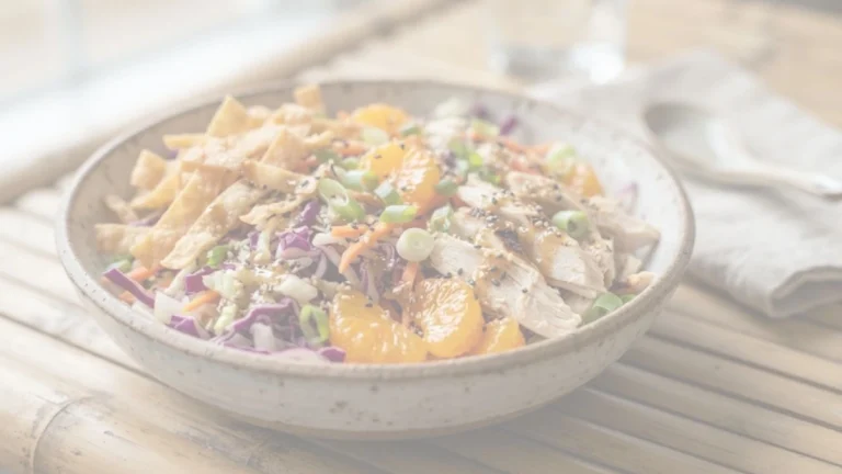 Crunchy Asian Chicken Salad with shredded cabbage, chicken, sweet mandarin oranges, crispy wontons, and sesame dressing